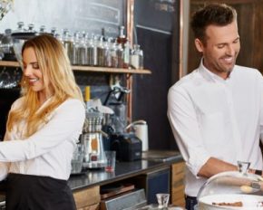 Two small business owner working in coffee shop prepaing coffee